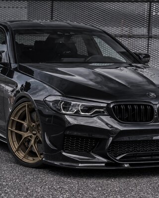 Чёрный BMW M5 с бронзовыми многоспицевыми дисками
